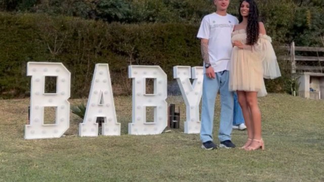 Gender reveal celebration shows parents-to-be in delight when blue smoke fills the background