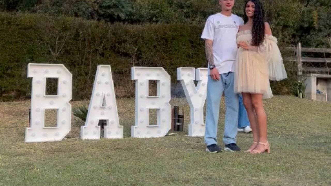Gender reveal celebration shows parents-to-be in delight when blue smoke fills the background