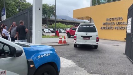 Relatives of Rio police raid victims wait for updates outside a morgue