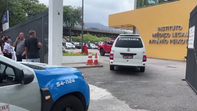 Relatives of Rio police raid victims wait for updates outside a morgue