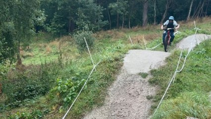Mountain biker loses control on trail and crashes into the grass