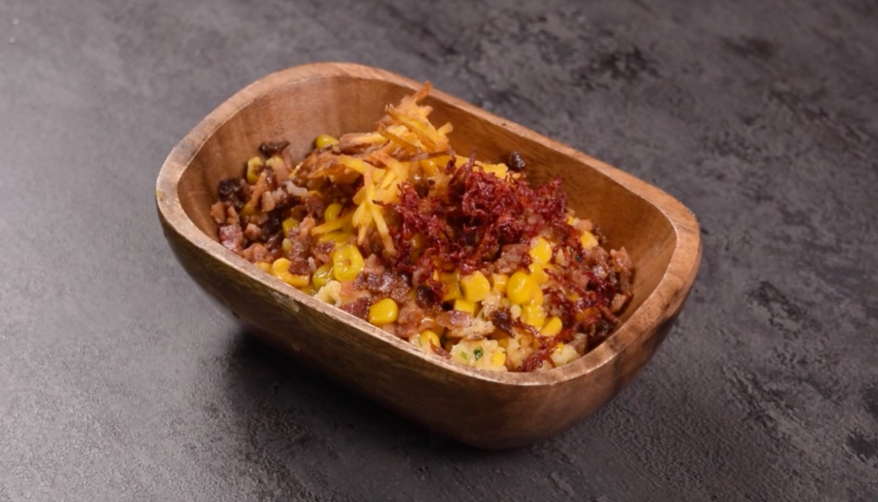 Esquites de maíz con remolacha frita, queso, tocineta y plátano verde