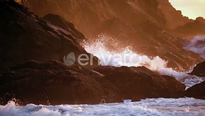 Ocean Waves Crashing On The Rocky Coastline And Cliffs During Golden Hour. - slow motion, zoom in sh