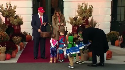 Trump puts candy on kid's head at White House Halloween party