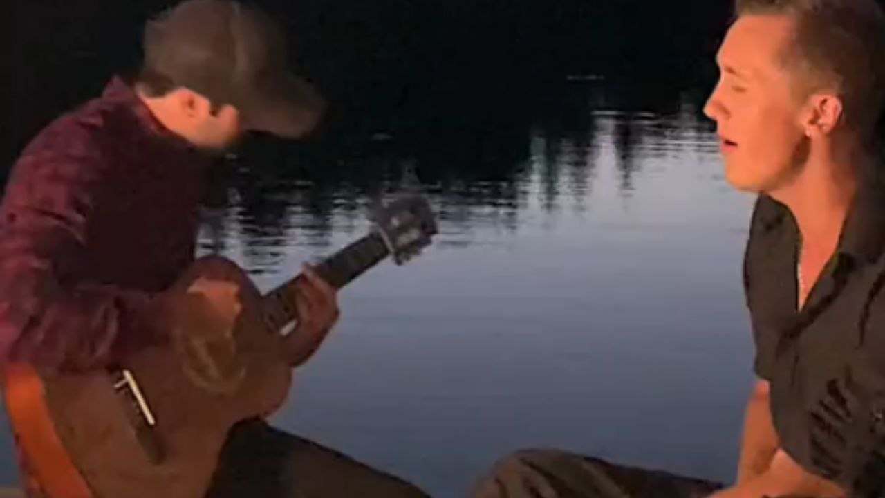 Two artists perform their song at a lake and subsequently fall in water