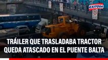 Tráiler que trasladaba tractor quedó atascado en el Puente Balta