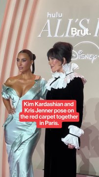 Kim Kardashian poses Kris Jenner on the red carpet.
