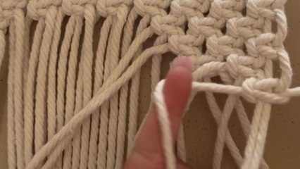 Artist makes a macrame bag with careful knots and steady focus
