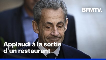 Nicolas Sarkozy applaudi à la sortie d'un restaurant après sa mise en liberté sous contrôle judiciaire