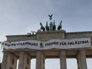 Pro-Palästina-Demonstranten hissen Banner auf dem Brandenburger Tor
