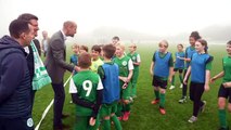 William greets young footballers as he opens new access road