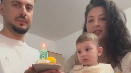 Impatient birthday boy grabs the cake before the celebration even begins