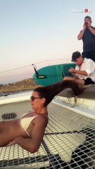Two girls embrace boat tour bliss as wind carries their hair in freedom
