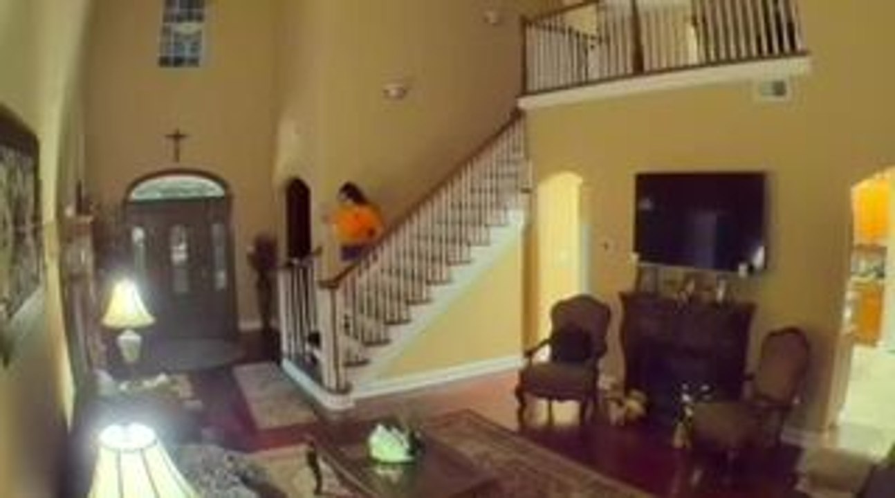Woman Slips on Rug While Carrying Her Cockatiel Down Stairs