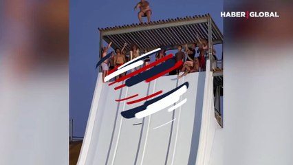 Su kaydırağının tepesinden havuza atlayan kilolu adam şaşırttı