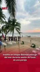 🌊 Una pareja disfrutaba su sesión de fotos cuando #Batman salió del agua como si fuera una escena de acción.