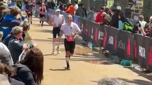 Matt Seiter crosses the finish line of half ironman