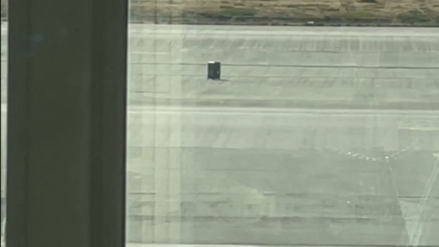 Suitcase glides on its own as if an invisible passenger was guiding it