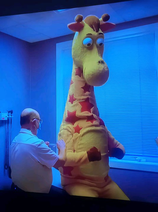 Geoffrey and the Doctor and the lady are hugging each other/Toys R Us Studios/Geoffrey's Vision