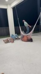 Man Trips and Falls While Trying to Jump Over Woman Resting in Hammock