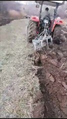 The land is ploughed with a tractor.