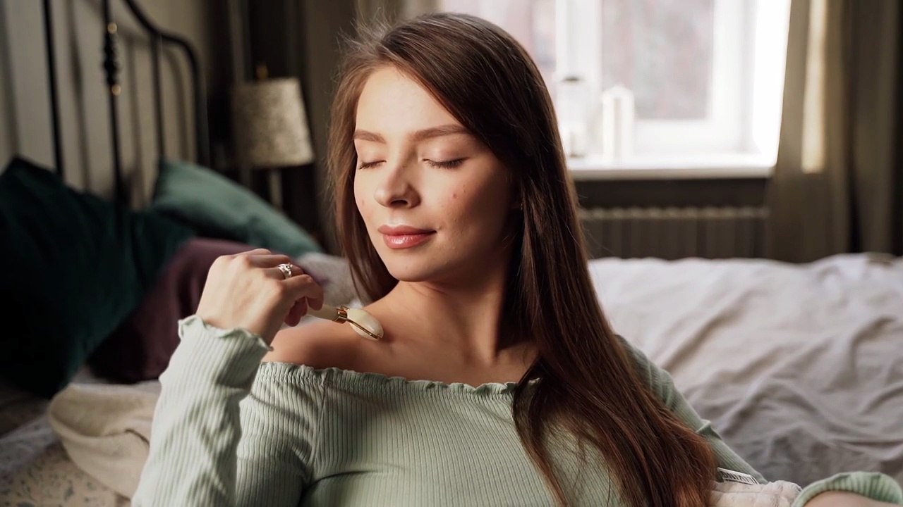 A Woman Using a Jade Roller