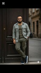 "Casual vibes 💁‍♂️! Guy chillin' by the doorway 🛗 in an olive green outfit 🍃 - shirt, pants, and an open jacket 🔓. Rockin' navy sneakers 🥿 and a sick watch 🕰️. Background's a blurry city street 🌆. #CasualStyle #OliveGreen #StreetChill"