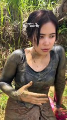 he beautiful village widow is pouring in the rice field