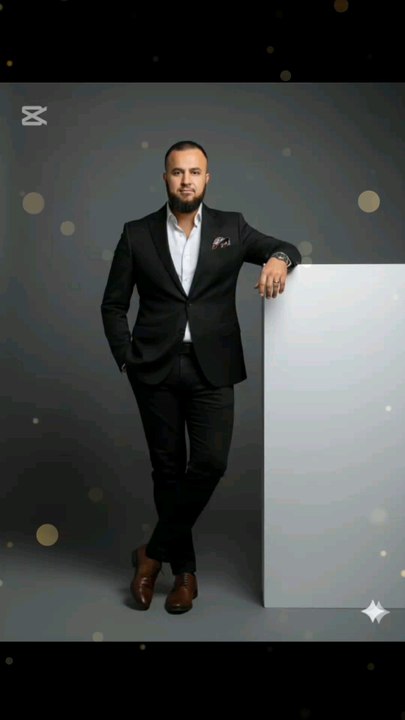 "Boss mode activated 🔥! Stylin' in a sleek black suit 💼, crisp white shirt 👕, and killer brown boots 🥇. Pocket square adds a pop of flair 😎. Leaning cool against a blank canvas 🖼️. #SuitsAndStyle #BusinessChic #PosingLikeABoss"