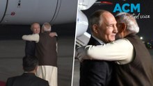 PM breaks protocol to hug Putin