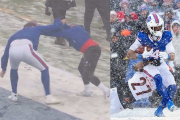 Bills players wrestling on the field in the downpour of snow in Buffalo