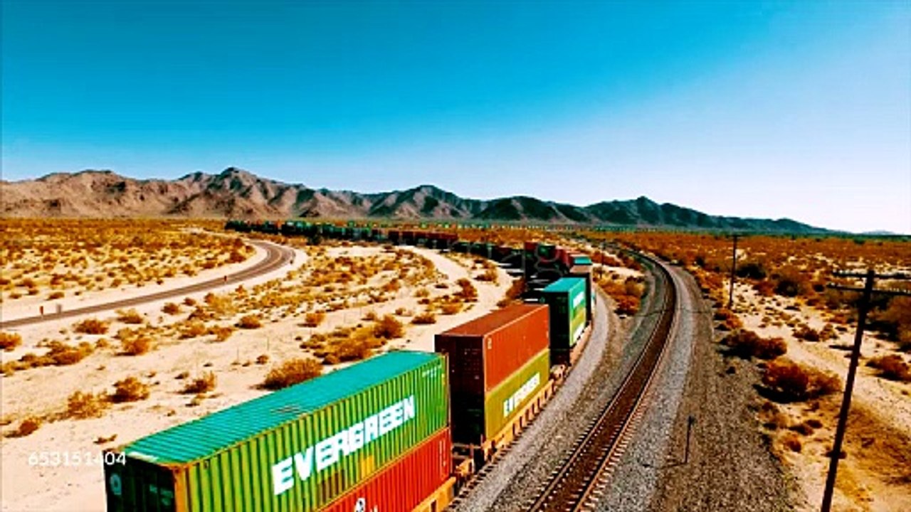 A large container locomotive travels down a railroad track in the American desert. - 4K stock videogettyimages-653151404-640_adpp