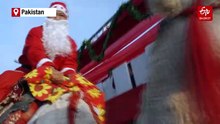 Santas Riding Camels Bring Christmas Joy To Pakistan's Capital