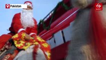 Santas Riding Camels Bring Christmas Joy To Pakistan's Capital