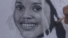 Artist creates a portrait of a girl on canvas with pencil and brush