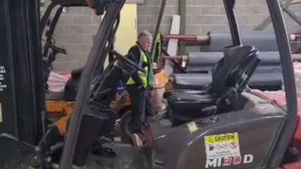 Man gets startled when a cracker pops loudly behind him at the workplace