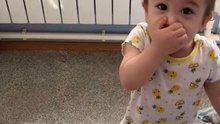 Tiny tot checks her weight and acts like she achieved a lifetime goal