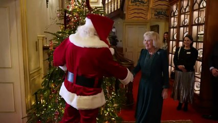 Queen Camilla greets Santa Claus during Christmas party