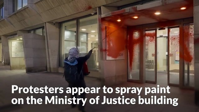 Protesters appear to spray red paint on Ministry of Justice building