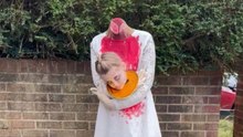 Girl’s Halloween look depicts a beheaded figure holding her head on a plate