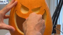 Professional pumpkin carver sculpts pumpkins to reveal a haunting faces