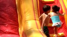 Toddler tries water slide for first time and goes bumping everywhere