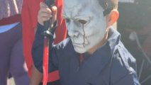 Two kids dressed as Michael Myers give each other death stares at Trunk or Treat