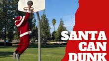 Santa Claus dunks while holding Christmas presents