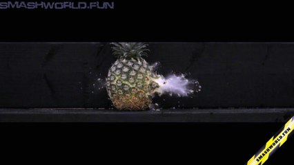 Slow motion shot of an expanding bullet hitting a pineapple