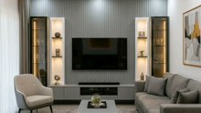 🔥 Modern luxury living room vibes! 🛋️✨ This sleek, grey‑toned lounge features a stylish TV wall with fluted paneling, amber‑lit recessed ceiling, and built‑in shelving that pops with warm LED accents. #ModernHome #LuxuryDecor #HomeStaging