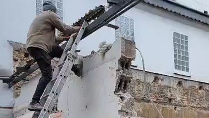 Demolition fail: Man conquers the wall but the door survives and stands tall