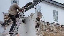 Demolition fail: Man conquers the wall but the door survives and stands tall