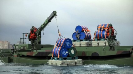 Taiwan drops "explosive barrels" in river defense drill as China encircles island