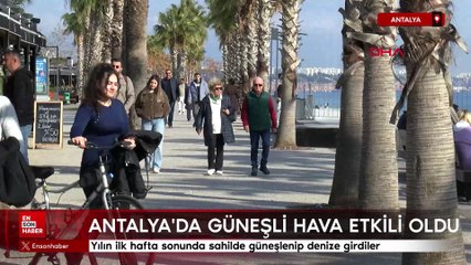Antalya'da yılın ilk hafta sonunda sahilde güneşlenip denize girdiler